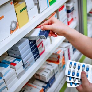 pharmacist-holding-medicine-box-and-capsule-pack-in-pharmacy-drugstore (1)