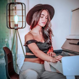 Young lady sittin in front of piano and looking at it. High quality photo